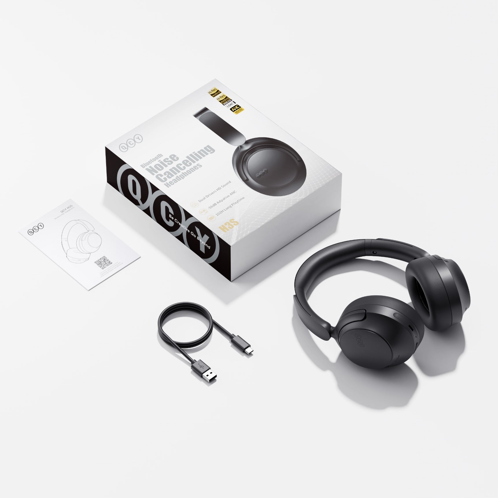 Casque Bluetooth à réduction de bruit QCY H3S noir avec câble de chargement USB-C et manuel.