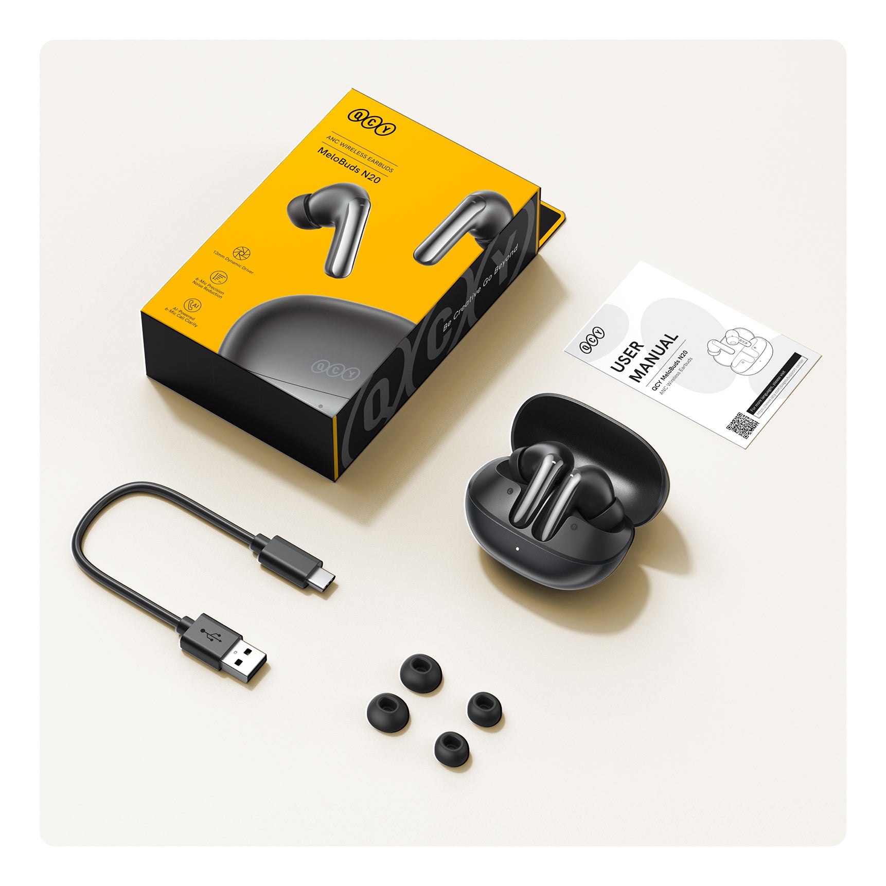 Écouteurs Bluetooth QCY MeloBuds N20 ANC avec boîtier de chargement, câble USB-C et embouts d'oreille de rechange.